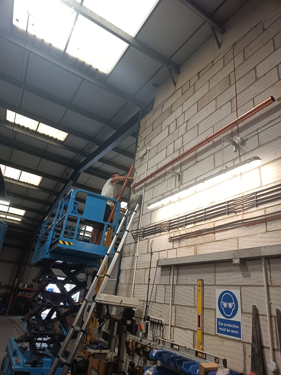 Scissor lift installation of high-level copper pipework