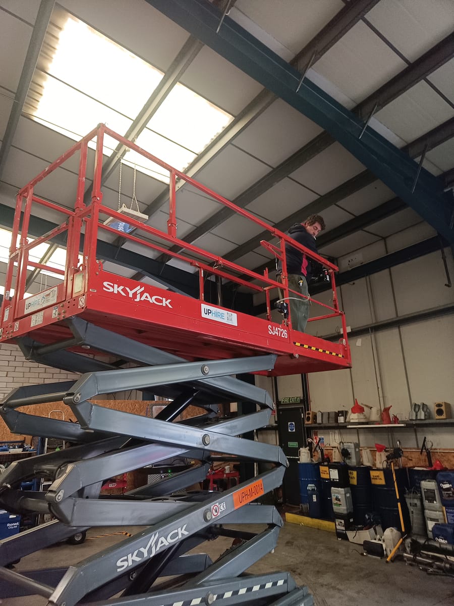 Technician carrying out commercial installation work at height